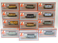 Eighteen Lima 00 gauge wagons, vans and tankers,