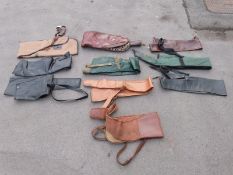 Ten various gun slips / cases, some leather and some padded.