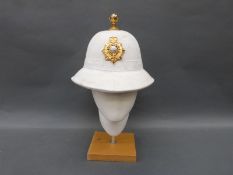 A Royal Marines officer's topee with gilt metal finial, 'Per Mare Per Terrem' badge,
