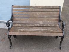 A garden bench with cast aluminium ends,