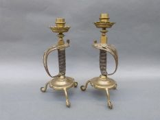A pair of Victorian novelty candlesticks formed as sword handles,