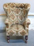 A 19thC or early 20thC wing back or porters chair with turned front legs