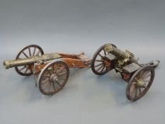 Two brass and wood model cannon, one marked Gatling USA 1885, the other with Russian Imperial crest,