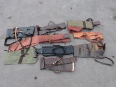 Ten various gun slips / cases, some leather and some padded.