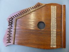 An early 20thC lap zither harp with 25 pairs of melody strings and six groups of bass strings in