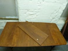 A retro Danish style extendable dining room table with shaped legs united by curved stretchers (H71