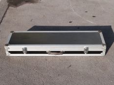A hard gun flight case with padded interior, 110x30x14cm.