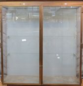 Ex Victoria & Albert Museum early 20thC two door glass display cabinet with bronzed frame,