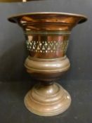 A large pierced copper pedestal jardiniere,