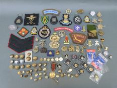 A quantity of military cap badges including 11th Hussars, 10th Hussars, Cyprus Regiment,