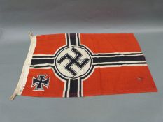 A Nazi German Kriegsmarine flag with indistinct maker's mark to edge and swastika with M below to