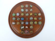 Thirty-two handmade glass marbles all with multi-coloured latticino decoration,