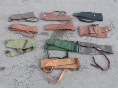 Ten various gun slips / cases, some leather and some padded.