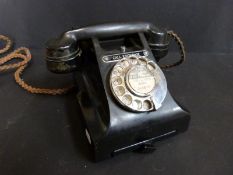 A black bakelite vintage telephone,