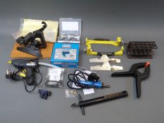 A collection of archery related items including two fletching jigs, various tapering tools,