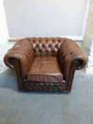 A Chesterfield brown leather chair