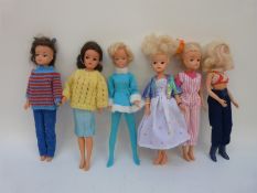 Six Sindy dolls, all in various outfits and with different hairstyles,