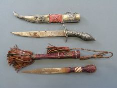 An Eastern dagger with ornate handle decoration, blade length 19cm,