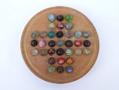 Thirty-two pee-wee handmade glass marbles some with multi-coloured swirl decoraton,