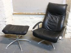 A modern designer leather chair and footstool
