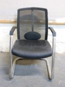 A chrome armchair and a floor standing fan