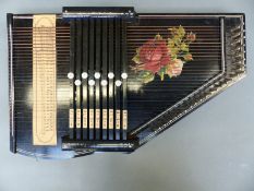 German auto harp with nine chord options and lacquered black finish with rose design