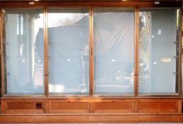 Ex Victoria & Albert Museum early 20thC four door glass display cabinet with bronzed frame,