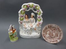 A Staffordshire figure of Queen Victoria and Albert together with a smaller 'fairing' and a Queen
