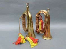 Two military bugles, one marked with broad arrow,