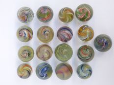 Seventeen handmade glass marbles all with multi-coloured latticino decoration,