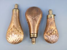 Three copper and brass powder flasks with embossed stylised leaf decoration, largest 18.