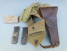 WWII American T45 leather pistol holster for a Colt 45 with webbing belt, field dressing pouch,