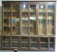 A large glazed oak bookcase, the top three sections each with double doors and adjustable shelves,
