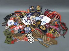 A collection of various mostly military cloth insignia badges of rank, formations,