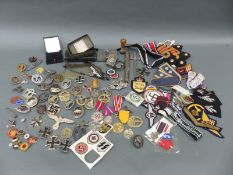 A quantity of WWII reproduction Nazi and other insignia and medals etc