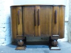 An Ercol Art Deco style dining suite comprising extending table and chairs and sideboard,
