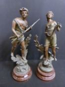 A pair of French Spelter figures on plinths 'L'Hymne Du Soir' and 'Braconnier',