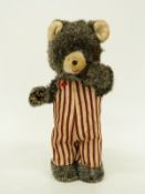 A Japanese clockwork tin-plate model bear, 17cm tall.