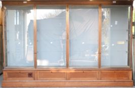 Ex Victoria & Albert Museum early 20thC four door glass display cabinet with bronzed frame,