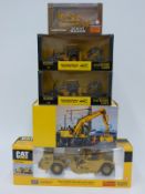 Six ERTL, Norscott and NZG diecast model construction vehicles including Bell Backhoe Loader,