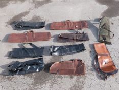 Ten various gun slips / cases, some leather and some padded.