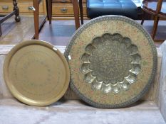 An Eastern circular brass table top and a further brass table top