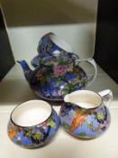 Crown Ducal tea for two decorated with exotic birds against a blue ground