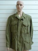 WWII US field jacket in 1943 pattern with hand painted motif on back, possibly flying tigers,