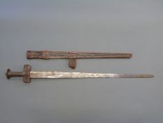 A 19th/20thC Eastern sword with copper pommel in tooled leather scabbard,
