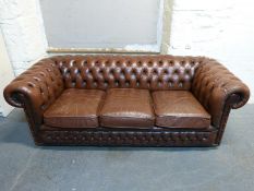 A Chesterfield brown leather two seater sofa