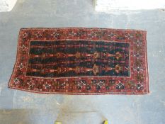 An Eastern wool rug with repeating geometric design,