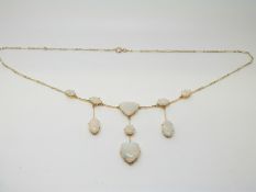 An Victorian/ Edwardian necklace set with oval, triangular and a heart shaped opal cabochons,