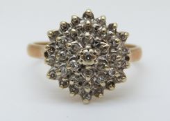 A 9ct gold ring set with diamonds in a cluster, 3.