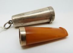 An amber cheroot holder with a 9ct gold collar in hallmarked silver holder